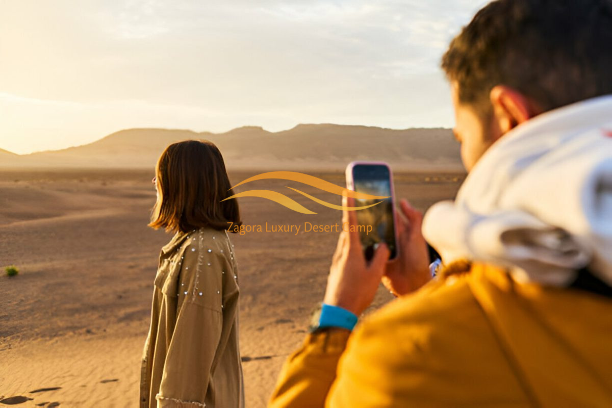 Couple enjoying a private luxury desert experience in Zagora Sahara Morocco at sunset