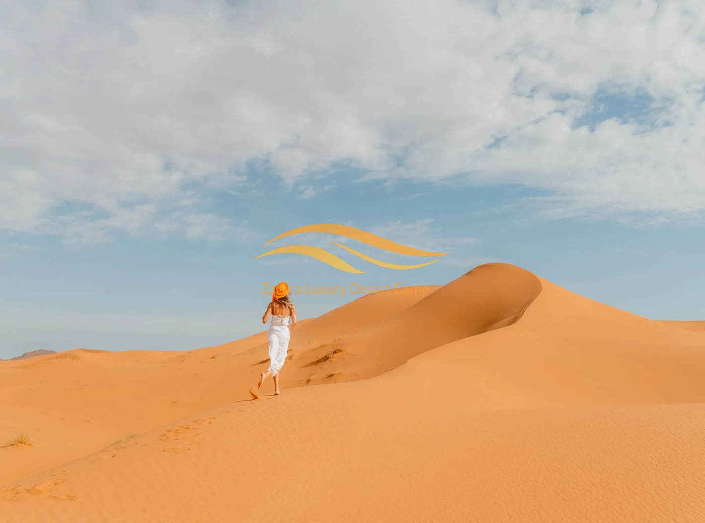 Traveler walking on sand dunes during Private Erg Chigaga Desert Tour from Zagora