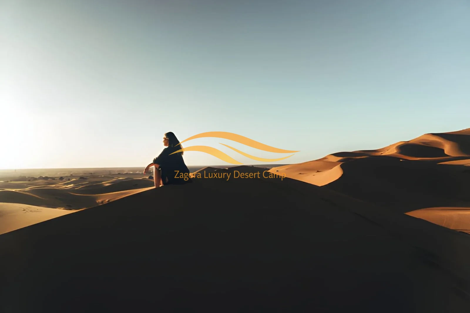 Traveler watching sunset in the Sahara Desert from Ouarzazate during Private Tours in Morocco