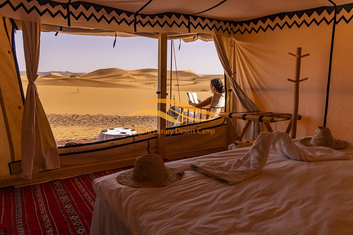 Woman relaxing outside a luxury desert tent in Erg Chigaga, Morocco